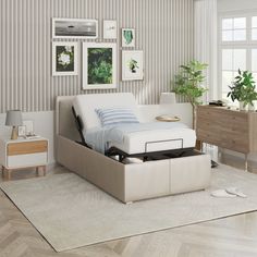 a white bed sitting on top of a wooden floor