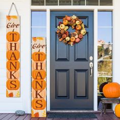 a front porch decorated for thanksgiving with pumpkins and other fall decorations on the door