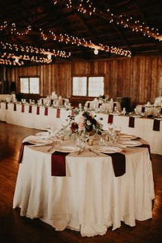 the table is set with white and red linens