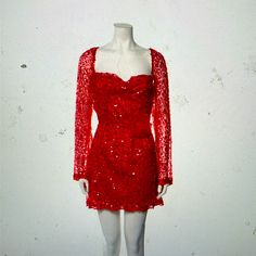 a mannequin wearing a red dress with sequins on it