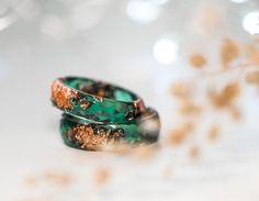 A beautiful faceted dark green resin ring with rose gold metallic flakes inside. This resin ring is perfect for stacking! It's faceted all the way around and it is so comfortable to wear. All my resin rings are handmade with self-made molds. they are also hand-sanded and polished, to be smooth and comfortable to wear. Given the nature of the resin, my rings may contain tiny bubbles and imperfections, but I always try to make them as perfect as possible. MEASUREMENT Width: 6mm/0.24in Thickness: 2 Unique Resin Crystal Ring Gift, Elegant Green Resin Jewelry, Copper Ring Jewelry For Anniversary, Nature-inspired Ring With May Birthstone For Gift, Handmade Resin Rings As A Gift, Nature-inspired Rose Gold Ring Jewelry, Unique Resin Rings For Gifts, Unique Green Resin Rings, Unique Green Resin Ring