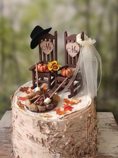 a cake decorated with two chairs and fall decorations