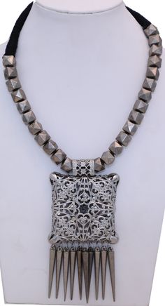 Vintage style modern boho silver necklace with a carved hollow oxidized silver pendant that has small silver conical drops falling down to give a fancy look.  The look is very dressy rustic tribal with oxidized silver rings running throughout the black rope neckline. #tlb #Handmade #BohoFestivalJewelry #CarvedPendantNecklace #OxidizedSilverNecklace Elegant Silver Metal Bead Jewelry, Elegant Silver Metal Beads Jewelry, Elegant Silver Necklace With Metal Beads, Bohemian Metal Jewelry With Large Beads, Silver Beaded Metal Necklace, Silver Beaded Necklace With Metal Beads, Bohemian Silver Necklace With Oxidized Finish, Festival Metal Jewelry With Large Beads, Elegant Silver Metal Bead Necklace