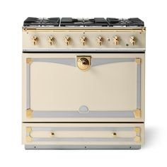 a white and gold stove top oven with two burners on each side, in front of a white background