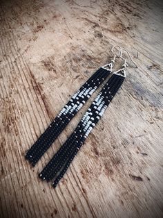 black and white beaded earrings on wooden table