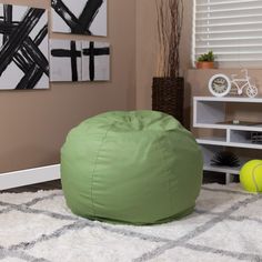 a green bean bag sitting on top of a white rug