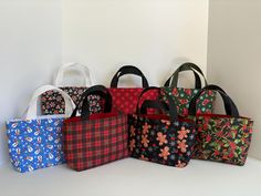 Christmas mini totes, perfect for reusable gift bags, a little purse, mini work tote, mini shopping tote.  Theses are small totes, so please check the measurements. Wide       10" Tall           5.5" Bottom    3" Handles   4" Red Christmas Gift Bags, Christmas Tote Bag As Gift, Christmas Tote Bag Gift, Christmas Gift Tote Bag, Christmas Rectangular Bag, Mini Totes, Mini Gift Bags, Reusable Gift Bags, Christmas Tote Bags