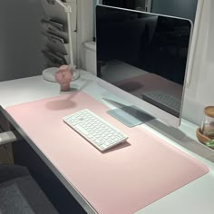 a desk with a keyboard, mouse and monitor on it