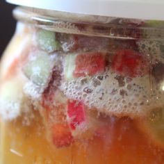 a jar filled with lots of different types of fruit inside of it's lid