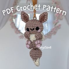 a crocheted teddy bear hanging from a hook with the text free pattern on it