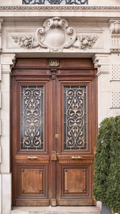 two wooden doors with ornate carvings on the front of a building in paris, france