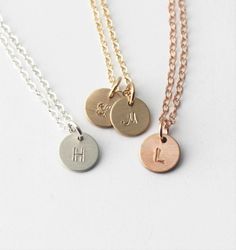 "Our tiny initial necklace is dainty and meaningful. This classic necklace is great for everyday wear or layering. Choose your number of discs and metal to wear your favorite initials close to your heart. D E T A I L S -Choose from 1-3 tiny discs -Disc measures 8mm -Choose 14kt Gold-Filled, Sterling Silver, or Rose Gold-Filled. -A high quality delicate link chain with a spring clasp. -Polished to a light satin finish. CUSTOM HAND STAMPING -Hand stamped with an initial. -This disc can also be lef Personalized Gold Necklace, Initial Necklace Silver, Dainty Initial Necklace, Necklace Layering, Initial Necklace Gold, Classic Necklace, Hand Stamped Jewelry, Layering Necklace, Stamped Jewelry