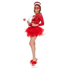 a woman in a red dress is holding a rose and posing for the camera with her hands on her hips