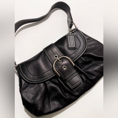 Coach Soho Pleated Buckle Should Bag With Front Flap! - Good Used Condition. - Material: Genuine Leather (Very Buttery And Supple!) - Color: Black With Subtle Metallic Finish (See Video) And Silver Hardware Why Am I Selling This Bag? The Quality Is Amazing, But I Haven't Reached For It In Years. It Is Difficult To Find Such Good Quality Bags These Days, So I've Hesitated To Let This One Go. The Leather Is So Supple, Metal Is Nicely Weighted, And The Inside Is Quite Generous And Can Hold More Than You'd Think! I'm Sad This Bag Is No Longer My Style. It Would Be A Perfect Casual Everyday Bag. Please Note There Are A Few Marks Throughout The Inside Of The Bag. They May Come Designer Hobo Bag With Silver-tone Hardware For Formal Occasions, Designer Formal Hobo Bag With Silver-tone Hardware, Elegant Formal Hobo Bag With Gunmetal Hardware, Classic Silver Soft Leather Bag, Classic Coach Hobo Bag With Silver-tone Hardware, Coach Shoulder Bag With Silver-tone Hardware, Classic Black Hobo Bag With Gunmetal Hardware, Classic Black Hobo Bag With Silver-tone Hardware, Classic Coach Shoulder Bag With Silver-tone Hardware