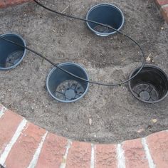 four empty buckets sitting on the ground