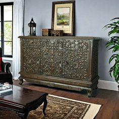 a living room filled with furniture and a painting on the wall