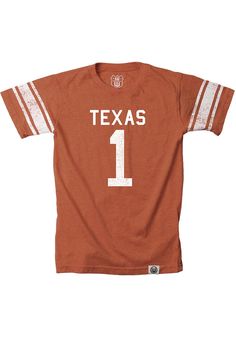 Get your future Longhorns fan ready for the tailgate in this Texas Longhorns Toddler Burnt Orange Short Sleeve Tee. This Texas Tee features a screenprint team graphic. Crew neck tee, Logo jock tag at hem, Distressed screen print, Striped sleeves, Poly/ cotton blend, Perfect for any young sports fan!, Import, Domestic Football Season Fan Merchandise Tops, Fan Merchandise Tops For Football Season, Varsity Graphic Print Top For Fan Gear, Team-colored Tops For Baseball Season Fan Merchandise, Team Colors Tops For Game Day, Tri-blend Fan Apparel T-shirt For Game Day, Football Season Fan Apparel Tops, Varsity Team-colored Tops For Game Day, Cotton T-shirt With Team Name For Football Season