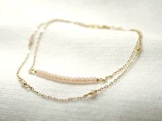 "Double strand beaded bar bracelet - dainty jewelry Tiny baby pink beads beaded on 14K gold filled chain. Double chain bracelet that's femininely dainty in soft shades of gold and blushing pink. measurements bead bar length 1\" please choose length at checkout ♦you can enter shop here! http://etsy.com/shop/illusy" Dainty Pink Beaded Chain Bracelet, Delicate Pink Beaded Chain Jewelry, Delicate Beaded Bracelets With Adjustable Chain, Dainty Rose Gold Beaded Bracelets, Dainty Double Strand Beaded Bracelets For Gift, Delicate Beaded Bracelets With Satellite Chain, Delicate Pink Beaded Bracelets For Everyday, Delicate Pink Beaded Bracelets, Delicate Pink Jewelry With Tiny Beads