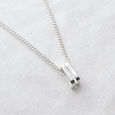 The polished rectangular link pendants are made from solid sterling silver and personalised with traditional hand stamps. Add multiple pendants and create a piece to tell your story. Each pendant can be personalised with names, dates or initials (up to 7 characters per tag). Individually handmade in our studio and presented in a bespoke Minetta box, ready for gift giving. Choose your chain style; 'minimal' or 'bold' recycled sterling silver: - 'Minimal' chain: 1.6mm trace chain - 'Bold' chain: 2 Classic Silver Necklaces With Engraved Text, Classic Silver Necklace With Engraved Text, Sterling Silver Name Necklace With Engraving Option, Silver Sterling Name Necklace With Engraving Option, Silver Name Necklace With Rectangular Pendant For Anniversary, Everyday Engraved Silver Name Necklace, Everyday Silver Rectangular Name Necklace, Everyday Rectangular Silver Name Necklace, Silver Necklace With Engraved Rectangular Pendant