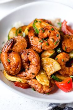 a white plate topped with shrimp and veggies