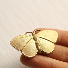 This moth or butterfly brooch is a solid brass metal stamping in a beautiful, deep gold colour.   The brooch measures 50mm (two inches) wide and 25mm (one inch) high. We have attached a gold plated brooch back with secure fastening. This piece of jewellery comes packaged in a nice recycled gift box with a handmade tag, all ready to give or keep. 🖤 FASTER SHIPPING 🖤 Need this fast? We offer a Faster Shipping option here: https://www.etsy.com/uk/listing/100107311/faster-shipping-priority-post-up Rosy Moth, Moth Brooch, Woodland Cottage, Silk Purse, Insect Jewelry, Handmade Tags, Butterfly Brooch, Photo Locket, Gold Colour