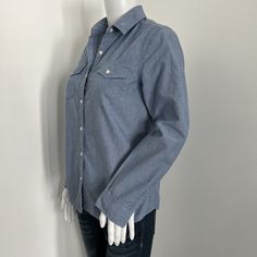 J. McLaughlinUS Women's Size XSBlue chambray button up collared top with long sleeves. Good condition. Please see pictures for details.MeasurementsShoulder | 15 inches seam to seam straight across back of the shirtSleeve | 25 inches center back of the shirt to the end of the cuffLength | 24 inches center base of the back of the collar to the end of the shirtChest Circumference | 18 inches x 2 = 36Please note that color may vary a small amount because of my lighting. If you have questions please ask and I would be happy to help! -Michelle Collared Denim Blue Blouse With Button Closure, Denim Blue Collared Blouse With Button Closure, Collared Denim Blue Blouse For Work, Denim Blue Collared Workwear Blouse, Denim Blue Collared Blouse For Work, Denim Blue Button-up Workwear Blouse, Blue Shirt With Roll-up Sleeves For Everyday, Blue Shirt With Roll-up Sleeves, Collared Denim Blue Cotton Blouse