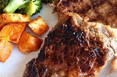 steak, potatoes and broccoli on a white plate