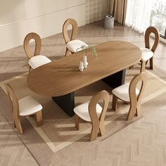 a dining table with chairs around it and a rug on the floor next to it