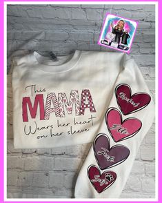 This Mama wears her heart on her sleeve crewneck sweatshirt personalized with children's names. Can also add a pet  Made on a white Gildan crewneck sweatshirt.  Can add as many hearts with names as needed. Please note they will be sized to fit on the sleeve.  Runs true to size. This Momma Wears Her Heart On Her Sleeve, White Custom Artwork Long Sleeve Sweatshirt, White Long Sleeve Sweatshirt With Custom Artwork, Personalized Long Sleeve Sweatshirt, Custom Text Long Sleeve T-shirt For Mother's Day, Personalized Casual Long Sleeve Sweatshirt, Personalized Pink Crew Neck Sweatshirt, Personalized Long Sleeve Sweatshirt For Mother's Day, Personalized White Sweatshirt For Family Matching