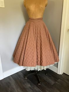 "1950's Vintage Quilted Circle Skirt in great condition. Unlined, metal zipper at back with two buttons.  Front waistband curves into a downwards point, very flattering. Small hole at inside waistband and broken thread ( see pictures for detail). Looks amazing over a crinoline. Size Vintage 13.  Very small waist. Measurements: Waist - 24\" Hip - Free Length from top of back waist band - 27\"" Vintage Circle Skirt, Vintage High Waist Pleated Skirt, High-waist Vintage Pleated Skirt, 1950s Style Full Skirt With Lining, 1950s Style Full Lined Skirt, Vintage Full Lined Skirt, Fitted Vintage Skirt For Vintage Fashion, Vintage Flared Lined Skirt, 1950s Style Fitted Pleated Skirt