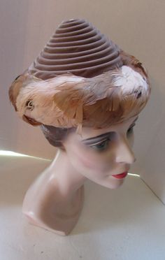 "SALE! 30% OFF! Most unusual shape vintage hat--conical shape Coils of Cocoa Tone Velvet on structured net Feathers in latte and cinnamon form band for brim 1940 Style 1950 Style Measurements: 6\" tall' 2 3/4\" wide feather brim; 20 1/2\" inner circumference Condition: good vintage condition--no stains, no holes. NOTE: anyone familiar with feather hats knows that feathers can go aloft at any time. If any feathers fall during transport, they can be re-glued. Original Listing Price: $65 Item 54198 Feather Hats, 1950 Style, 1940 Style, Unusual Hats, Hat Inspiration, Large Brim Hat, Bridal Gowns Vintage, 1950 Fashion, Black Lampshade