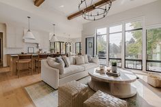 a living room filled with furniture and lots of windows