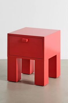 a small red table with two drawers on each side and one drawer at the top