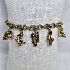 "Vintage 1950s Coro charm bracelet. This bracelet measures 7\" long and unfortunately it only has 9 out of the 10 commandments charm. It's in good condition, just missing 1 charm.☹️ It is priced accordingly. Please contact me with any questions.  Note: Image colors may vary based on computer resolution. Measurements are approximate" Vintage Charm Brass Bracelet, Vintage Brass Charm Bracelets, Vintage Charm Bracelet With Lobster Clasp, Vintage Adjustable Bracelet With Dangling Charms, Collectible Vintage Charm Costume Bracelet, Vintage Adjustable Bracelets With Dangling Charms, Vintage Brass Bracelets With Charm, Vintage Adjustable Charm Bracelet With Dangling Charms, Vintage Adjustable Charm Bracelet