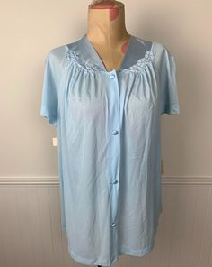 Make sure to check out all of the vintage items in my Etsy shop including lots of great clothing. I gladly combine shipping, and I do ship internationally. This is a vintage blue nylon short robe or nightgown. New with tags. Buttons up the front. Vanity Fair. Ladies' size 34. Short sleeves. Bust is approximately 40 inches. It is approximately 25 inches long from top of shoulder to bottom hem. 1089 Fitted Blue Sleepwear For Home, Vintage Blue Nightgown For Hospital, Vintage Light Blue Nightgown For Spring, Vintage Blue Sleepwear, Vintage Blue Nightgown For Bedtime, Vintage Blue Nightgown For Home, Vintage Light Blue Summer Nightgown, Blue Vintage Nightgown, Women's Nightgowns