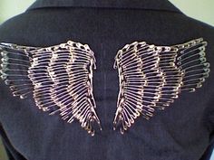 the back of a woman's jacket with wings on it