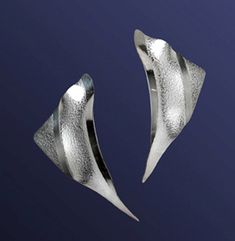 The Arc design has been a staple of the KNJewelers studio, proving a classic will ever remain a classic. Light as a feather, these earring gently trace the jawline. They are so comfortable that you'll forget you're wearing these embossed, beautifully formed earrings. The Arc is a must have and a classic brought to you by KNJewelers. Modern Sterling Silver Ear Cuff For Formal Occasions, Modern Clip-on Earrings With Polished Finish, Modern Silver Ear Cuff For Formal Occasions, Modern Pierced Ear Cuff For Formal Occasions, Modern Wrap Earrings For Formal Occasions, Modern Silver Ear Cuff, Modern Silver Wrap Earrings For Formal Occasions, Modern Sterling Silver Clip-on Earrings, Arc Design