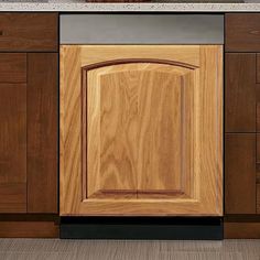 a kitchen with wooden cabinets and granite counter tops on each side, along with a white sink