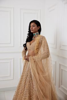 Gold mirror and zardozi embroidered tulle lehenga paired embroidered full sleeve blouse with feather detailing and tulle dupatta with embroidery and feather border.From Chamee and Palak's The Romantics collection.DELIVERY TIMEPlease allow 8-12 weeks for your outfit to arrive.FABRIC DETAILSOrganza, Silk, NetProfessional cleaning only. Glamorous Tissue Silk Sets With Zari Work, Glamorous Tissue Silk Choli For Festive Occasions, Glamorous Traditional Drape Sets With Dupatta, Glamorous Festive Tissue Silk Choli, Glamorous Hand Embellished Sets For Eid, Glamorous Tissue Silk Lehenga With Zari Work, Bollywood Style Hand Embellished Saree Sets, Glamorous Hand Embellished Saree Set, Festive Hand Embellished Saree Sets