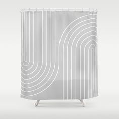 a white shower curtain with an abstract design on the front and back side, in grey