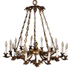 an antique chandelier with many candles hanging from it's arms and chains