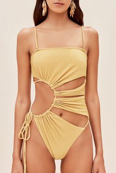 The Allegra one piece features signature Cult Gaia cutouts in a sunburst form. An adjustable tie at the right hip allows for secure fit. Shoulder straps are removable for customized wear. 10% of her fabric is composed of metallic paillettes to give some refined shine. She is slightly textured, which provides an effect of extra coverage. A gold-toned, brushed brass Cult Gaia logo can be found at the center back. Cut Out One Piece, Creation Couture, Cult Gaia, Cute Swimsuits, Womens Bathing Suits, Outfit Inspirationen, Womens Swimwear, One Piece Swimsuit, Ideias Fashion