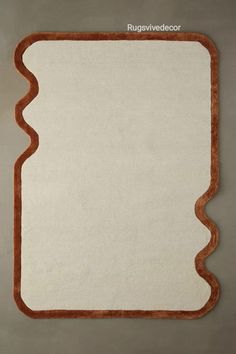 an area rug with scalloped edges in white and brown