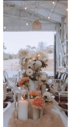 the table is set with candles and flowers