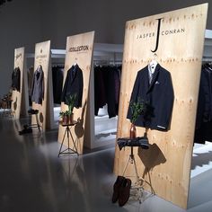 there are many suits on display in the store