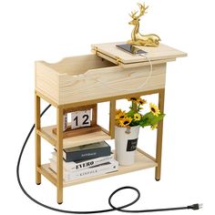 a small wooden table with some books and a clock on it's shelf next to a plant