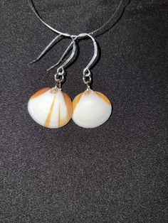 Hand made, hand picked from brevard county beaches Unique Nickel-free Earrings For Beach, Orange Dangle Jewelry For Beach, Orange Drop Earrings For Beach, Orange Drop Earrings For The Beach, Unique White Beach Earrings, Handmade Coastal Jewelry For Gifts, Handmade Coastal Style Jewelry Gift, Unique Round Earrings For Beach, Nickel-free Orange Jewelry For Beach