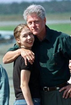 an older man and young woman hugging each other on the tarmac at an airport