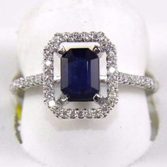 an engagement ring with a blue sapphire surrounded by diamonds