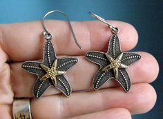 Featured is this wonderful pair of vintage sterling silver and 14k solid gold starfish earrings by designer Art's Elegance. This rare pair is of the highest quality. Hundreds of little round balls make of the texture of this beautiful sea creature. In the center is a solid 14k yellow gold star that has the same texture, with the addition of diamond cut edges and the tiniest of balls around the edges and middle of the star. These earrings are hallmarked, "AE" and stamped 925, 14K. The stars measure 1" in diameter and the total length is 2".  I have not tried to polish these, will leave any polishing up to the new owner.  To me they look ready to wear.   **All of my listings are vintage, which means they will naturally show some signs of wear. All jewelry measurements are listed in the descr Unique Starfish Jewelry As A Gift, Unique Starfish Charm Jewelry As Gift, Unique Jewelry With Starfish Charm As Gift, Nickel-free Starfish Earrings Ocean-inspired, Sterling Silver Starfish Earrings, Elegant Starfish Charm Earrings As Gift, Elegant Starfish Charm Earrings For Gift, Elegant Handmade Starfish Earrings, Starfish-shaped Nickel-free Earrings For Gifts